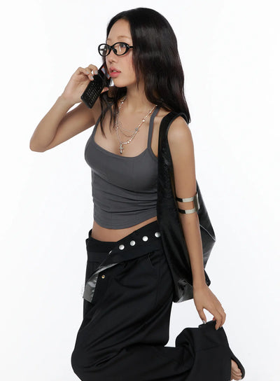 LEWKIN Flared Panel Sleeveless Top CL510 Dark gray side-shot on model holding phone, fitted ribbed crop silhouette with panel seams, styled with black wide-leg pants