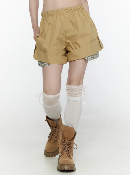 LEWKIN Floral Banded Shorts IL521 Beige front crop shot on model wearing boots and sheer knee socks with floral inner layer visible