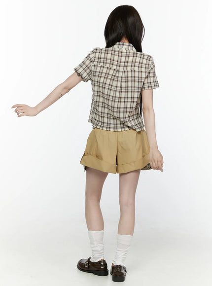 Floral Banded Shorts IL521 Beige full-length front shot on model in plaid crop shirt looking down, walking pose with loafers and socks
