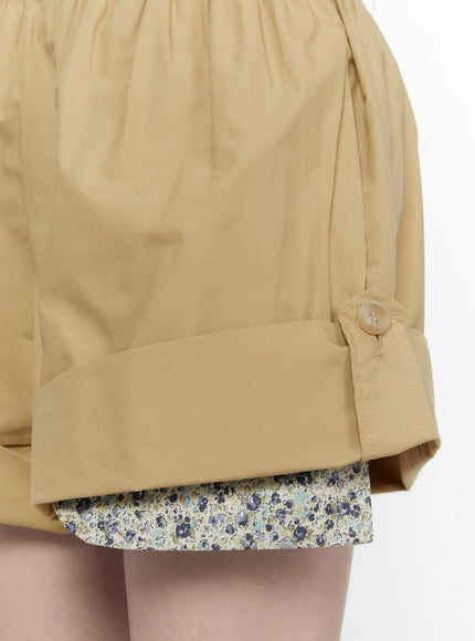 Floral Banded Shorts IL521 Beige close-up detail of cuffed hem with button tab and blue ditsy floral inner shorts layer peeking below