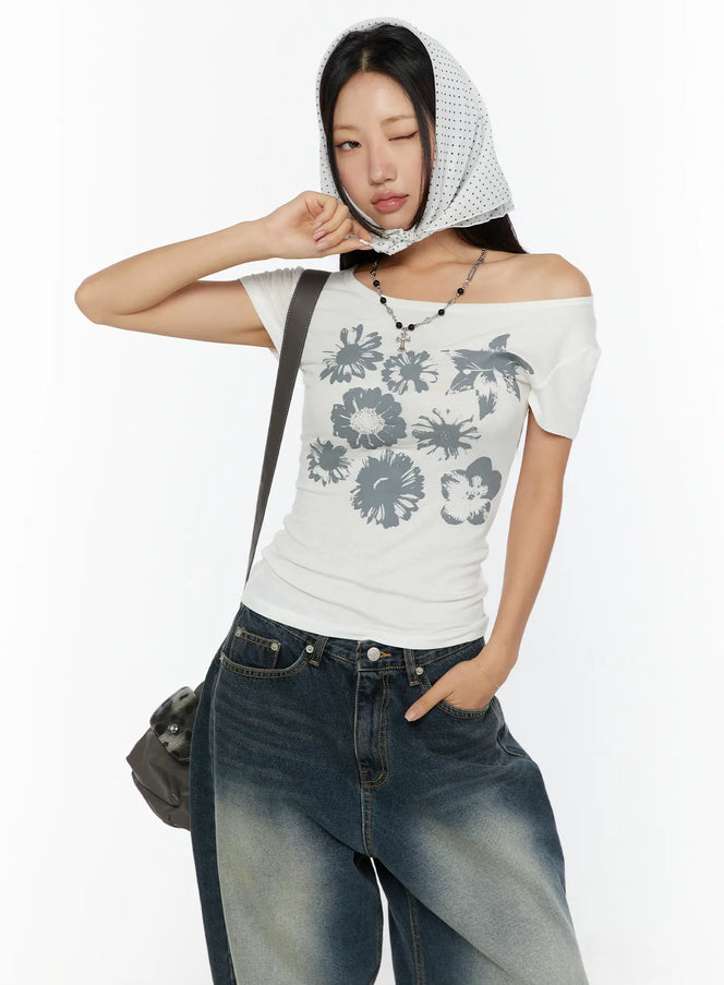 LEWKIN Floral Graphic Round-Shoulder Top CU529 White front shot on model wearing polka-dot head scarf, off-shoulder styling, gray floral print, ribbed cotton
