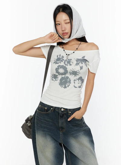 LEWKIN Floral Graphic Round-Shoulder Top CU529 White front shot on model wearing polka-dot head scarf, off-shoulder styling, gray floral print, ribbed cotton