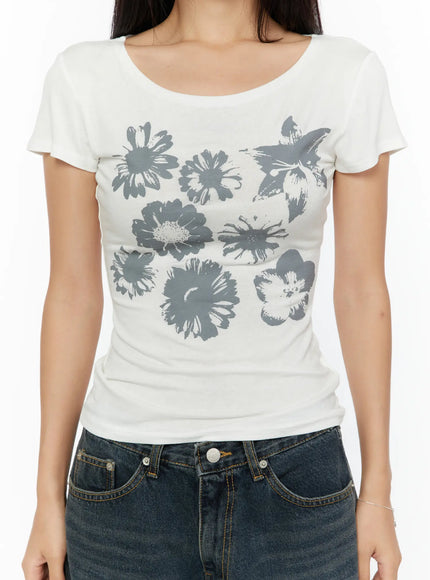 Floral Graphic Round-Shoulder Top CU529 White close-up front detail shot on model showing gray daisy and floral graphic print across chest, ribbed cotton, scoop neckline
