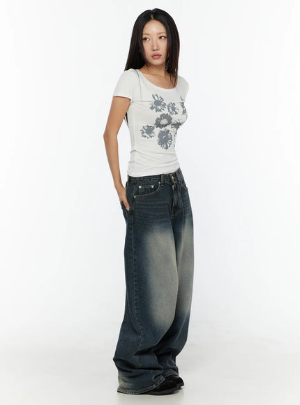 Floral Graphic Round-Shoulder Top CU529 White side shot on model looking away, scoop neckline and short sleeve silhouette visible, ribbed stretch fabric with floral print