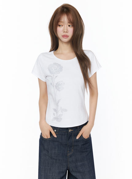 Floral Graphic Short Sleeve Top IU525 White front shot model hands in pockets paired with wide-leg dark denim cross-stitch rose graphic cotton tee