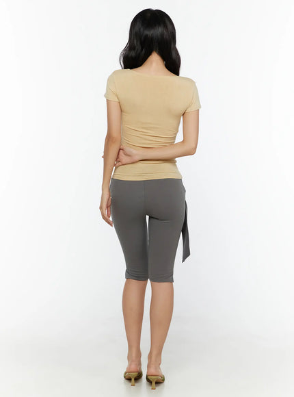 Floral Graphic Tee CU526 Yellow back model shot revealing clean plain back of slim-fit cap sleeve tee styled with gray tie-waist biker shorts