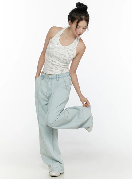 Floral Halter Top CL521 White full-body front view on model bending forward, showing floral ribbed crop silhouette paired with wide-leg light denim