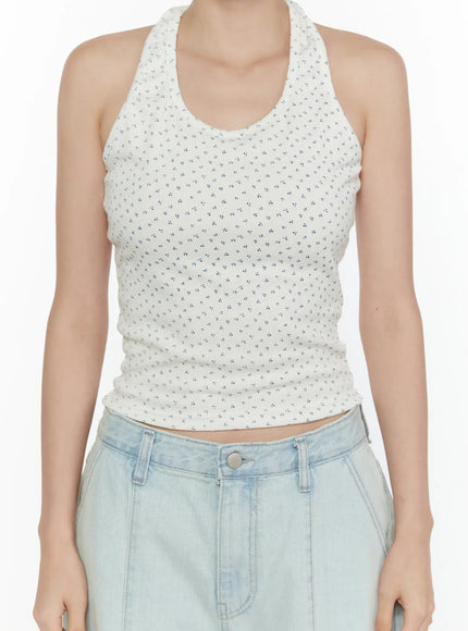 Floral Halter Top CL521 White close-up front shot on model, highlighting halter neckline, tiny blue floral print on ribbed white fabric, cropped hem