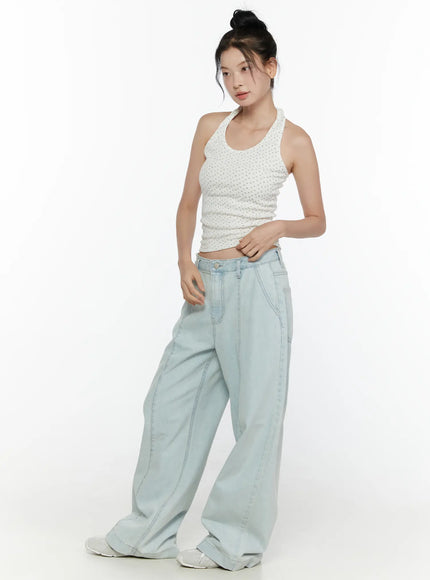 Floral Halter Top CL521 White three-quarter side view on model facing left, showing halter strap detail, ribbed floral texture, and cropped waist with wide-leg denim