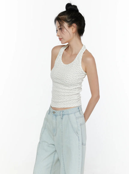 Floral Halter Top CL521 White side view on model looking left, hand in pocket, revealing side ruching of ribbed floral crop and halter neck tie detail
