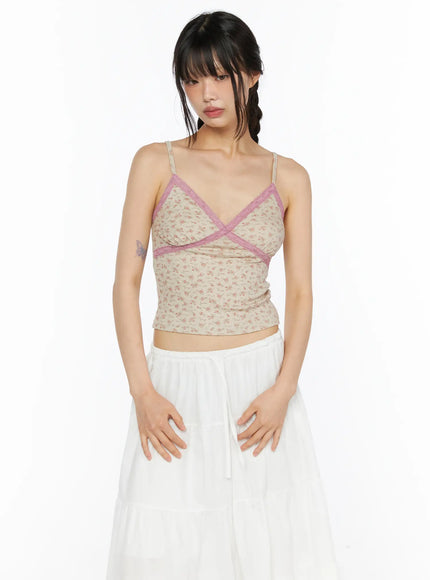 Floral Lace Trim Cami CU530 Beige front close-up shot model wearing beige floral ribbed knit cami with pink lace cross-body trim and V-neckline paired with white skirt
