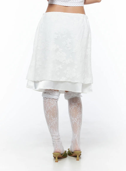 Floral Midi Skirt CU523 White back shot on model showing A-line floral jacquard skirt with double-layer hem and lace thigh-high stocking styling