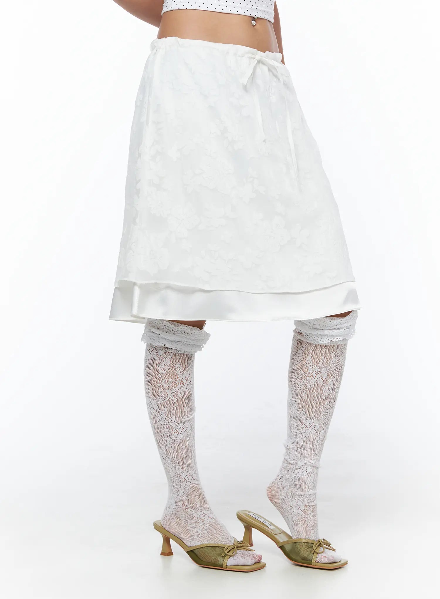 Floral Midi Skirt CU523 White side shot on model revealing layered hem detail and floral jacquard texture paired with lace knee-high socks