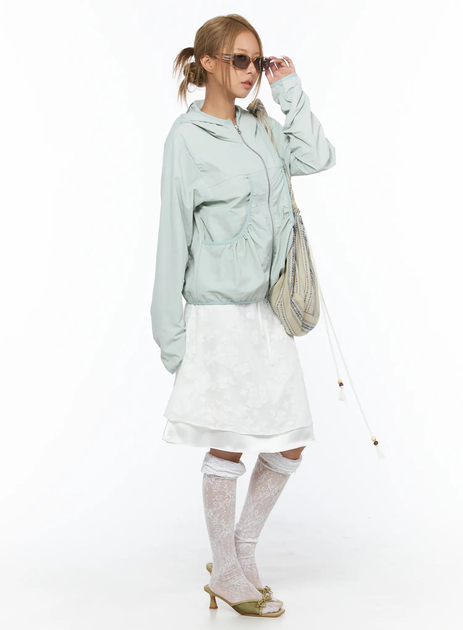 Floral Midi Skirt CU523 White styled shot on model with mint zip-up jacket and patterned shoulder bag showing full outfit coordination