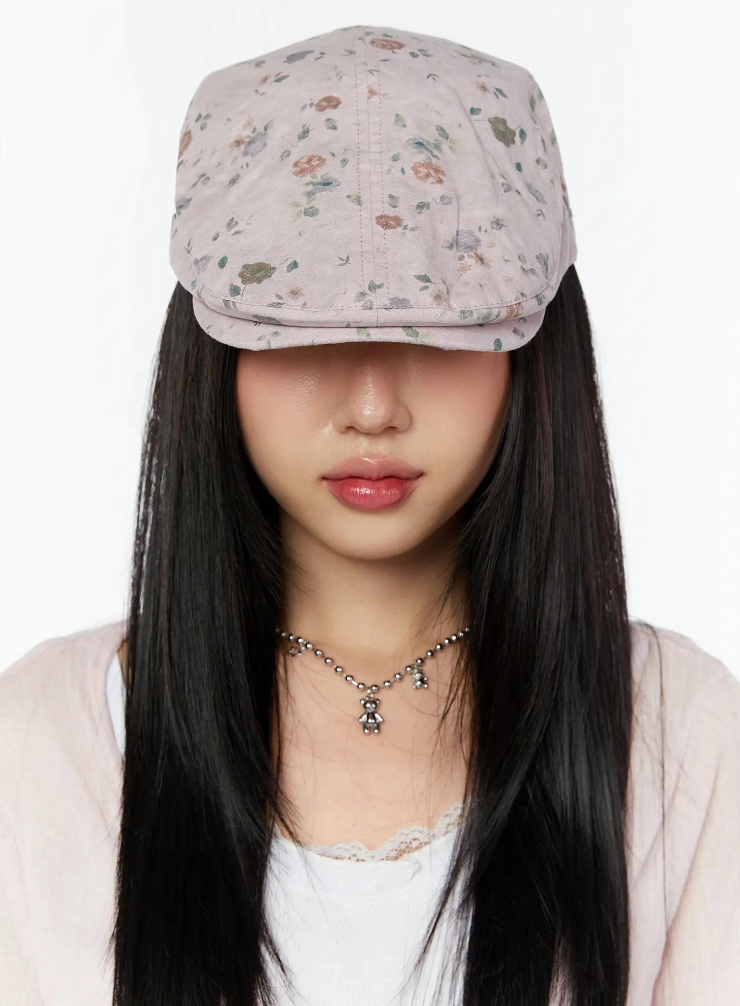 Floral Print Flat Cap IU524 Pink close-up front model shot brim pulled low over eyes showing ditsy floral print fabric texture