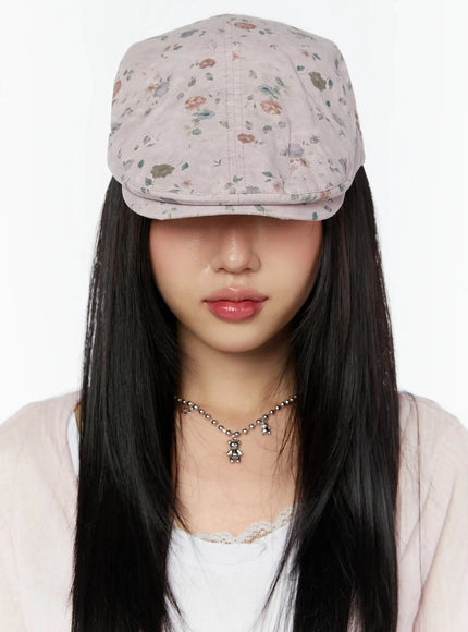 Floral Print Flat Cap IU524 Pink close-up front model shot brim pulled low over eyes showing ditsy floral print fabric texture