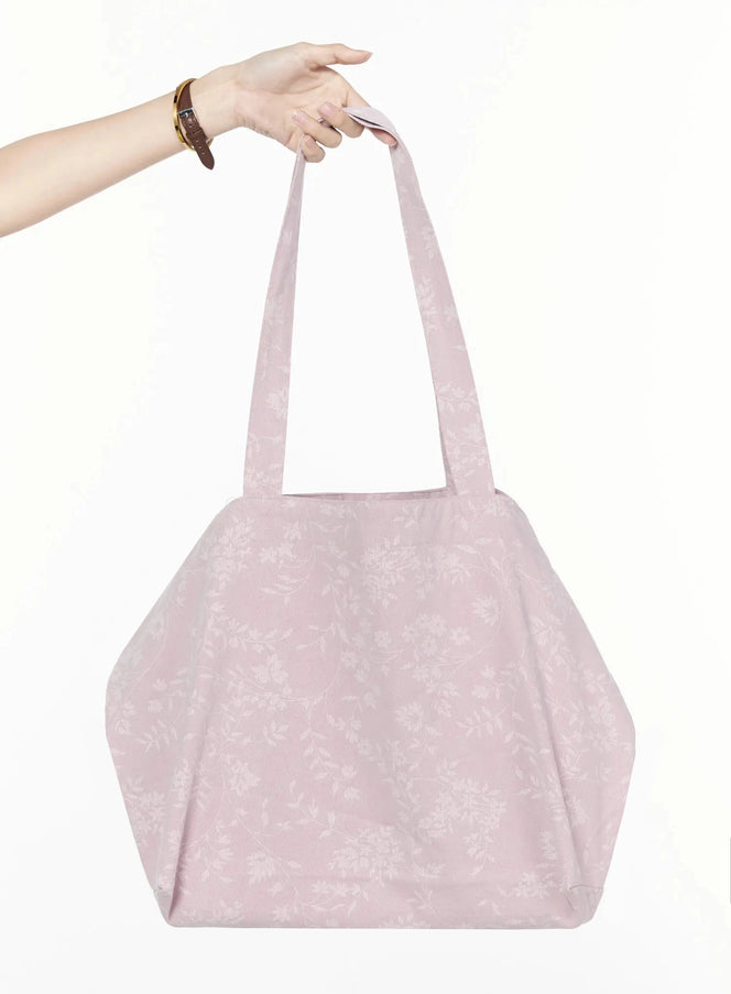 LEWKIN Floral Print Tote Bag IL516 Pink front view held by model hand showing floral jacquard texture and structured trapeze silhouette