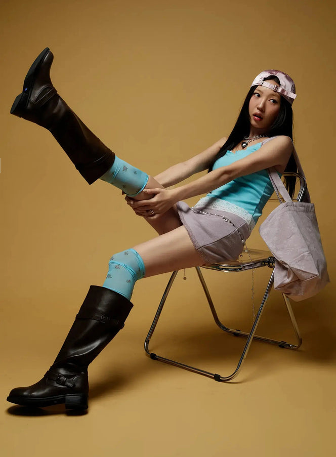 Floral Print Tote Bag IL516 Pink styled on seated model wearing teal tank and mini skirt with bag draped over chair arm