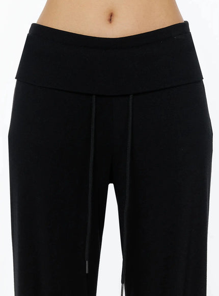 Fold-Over Drawstring Sweatpants IL509 Black close-up detail shot showing fold-over waistband drawstring with metal tips and wide-leg silhouette