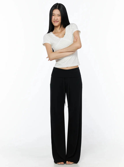 Fold-Over Drawstring Sweatpants IL509 Black full-body front shot model arms crossed styled with white polka dot crop top and clear heels