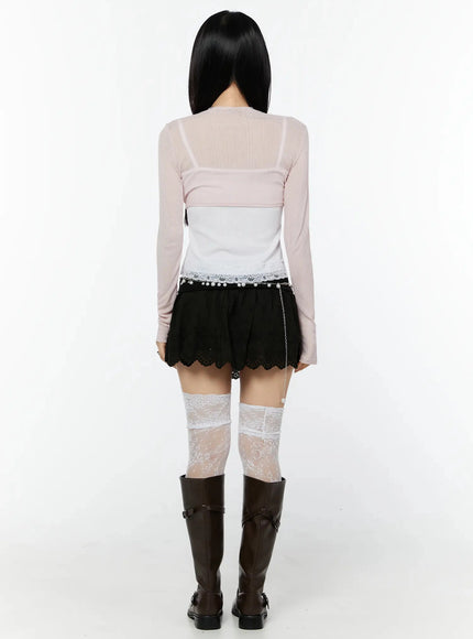 Foldover Eyelet Lace Mini Skirt IU524 Black back full-body shot on model styled with pink cardigan chain belt white lace thigh-high socks and dark knee-high boots