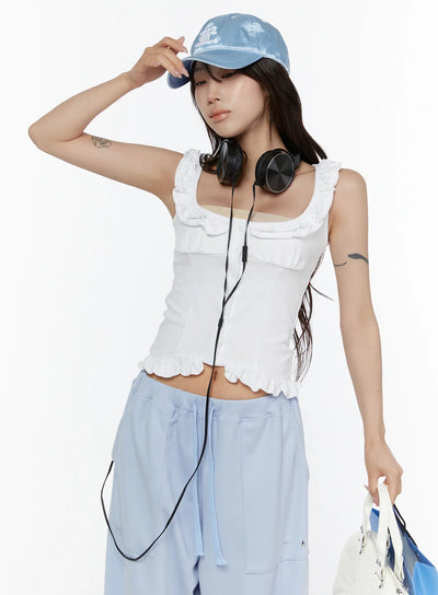 LEWKIN Frill Button Sleeveless Top CL507 White S/M close-up front on model wearing blue cap and headphones, ruffled neckline and hem detail visible