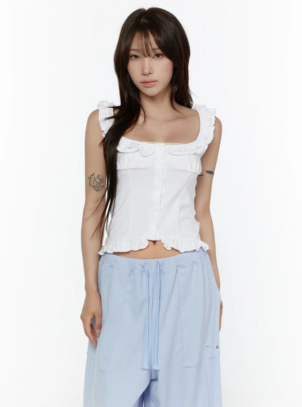 Frill Button Sleeveless Top CL507 White front on model cropped waist-up shot showing button placket, ruffle neckline trim and scalloped hem detail