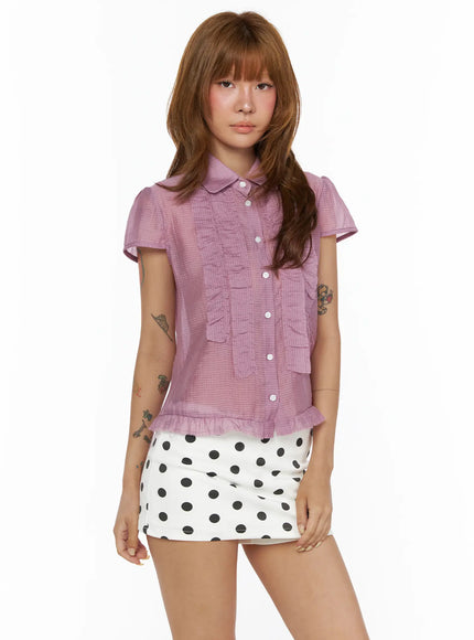 Frill Sheer Blouse CL503 pink front model shot, short-sleeve blouse with tiered ruffle placket and peplum hem, styled with polka dot mini skirt