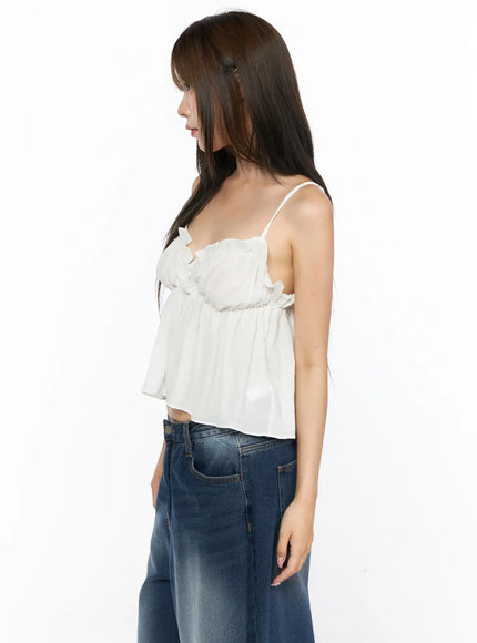 Frill Sweetheart Blouse Tank Top CL514 White side shot on model showing ruffle trim empire waist silhouette spaghetti straps and flowy crop length paired with blue denim jeans
