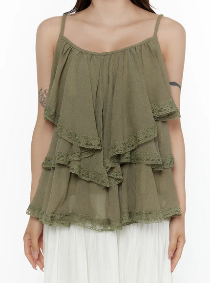 Frill Tiered Lace Sleeveless Top CL507 Dark green cropped front shot on model hands clasped showing crinkle fabric texture and triple lace-trimmed tiers