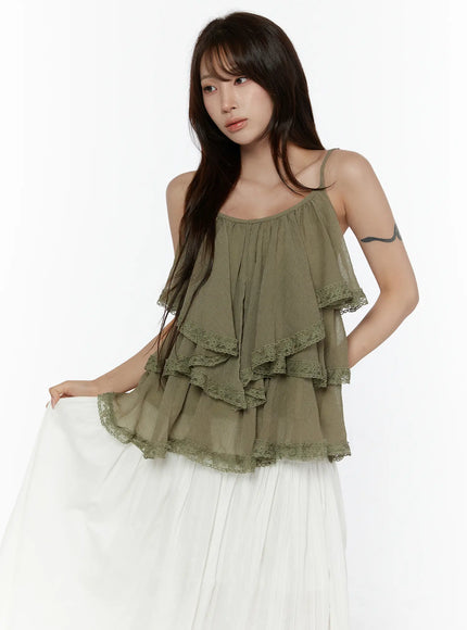 Frill Tiered Lace Sleeveless Top CL507 Dark green front shot on model lifting white skirt hem revealing lace-trimmed tiered ruffle layers and crinkle texture