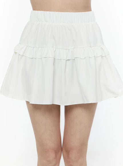 Frill Tiered Mini Skirt IL506 White close-up front shot on model showing elastic waistband, double tiered ruffle detail and flared silhouette