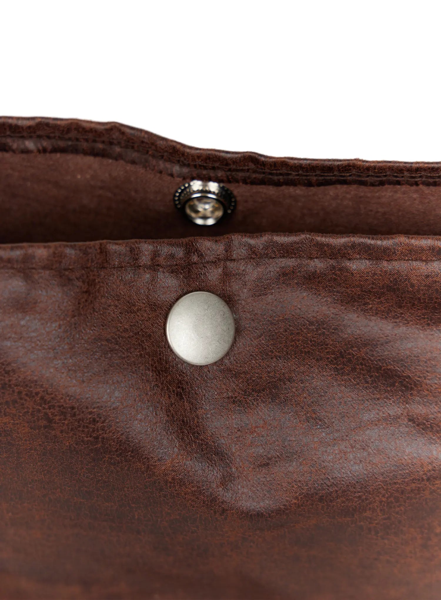 Fringe Studded Shoulder Bag CU524 Brown close-up detail of knotted strap top with small silver studs on distressed brown faux leather