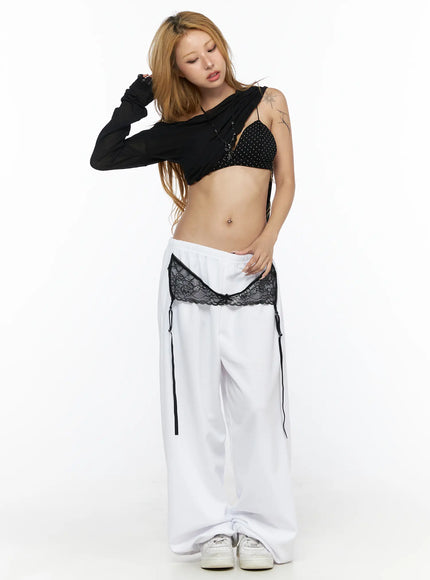 Garter Belt Graphic Wide-Leg Sweatpants CL528 White full-body front view on second model styled with black polka-dot bralette, lace garter waist detail visible