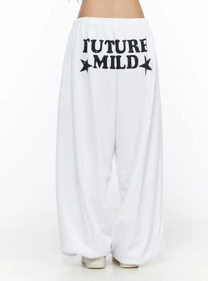 Garter Belt Graphic Wide-Leg Sweatpants CL528 White back view on model, FUTURE MILD distressed star graphic print clearly visible on back yoke, wide-leg silhouette