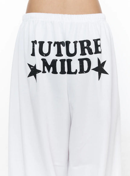 Garter Belt Graphic Wide-Leg Sweatpants CL528 White close-up back detail of distressed FUTURE MILD star graphic print on waistband area