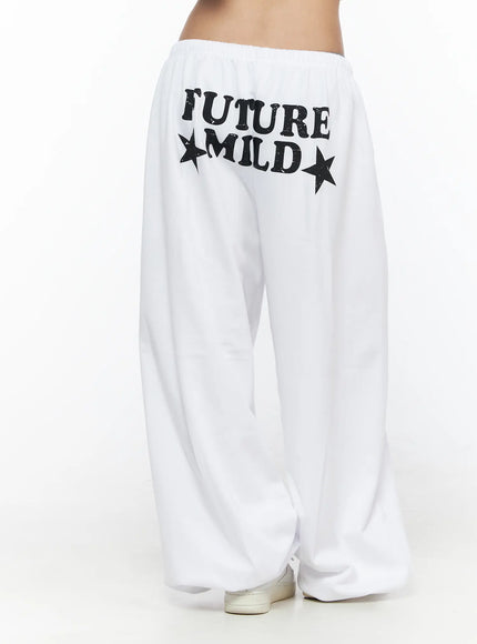 Garter Belt Graphic Wide-Leg Sweatpants CL528 White back view on model cropped, showing FUTURE MILD star graphic print and wide-leg pooled hem