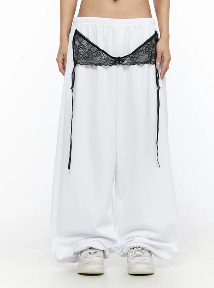 LEWKIN Garter Belt Graphic Wide-Leg Sweatpants CL528 White front view on model, cropped shot showing black lace garter detail and wide-leg silhouette, Size S/M
