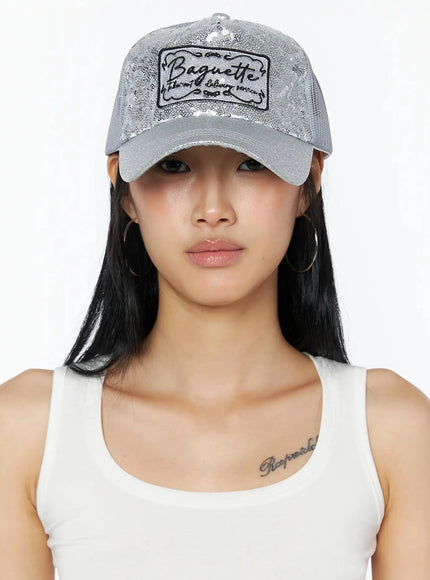 Glitter Patch Trucker Cap IL509 Silver front on model direct gaze full sequin panel Baguette patch clearly visible with hoop earrings