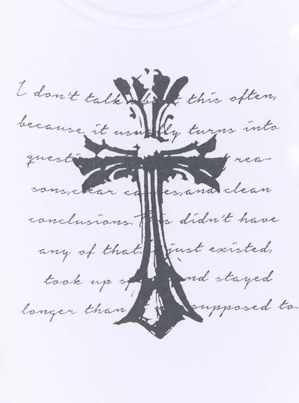 Gothic Cross Slim Fit Top IU525 White close-up flat detail shot, dark gothic ornate cross with full cursive script text print on white fabric, scoop neckline visible