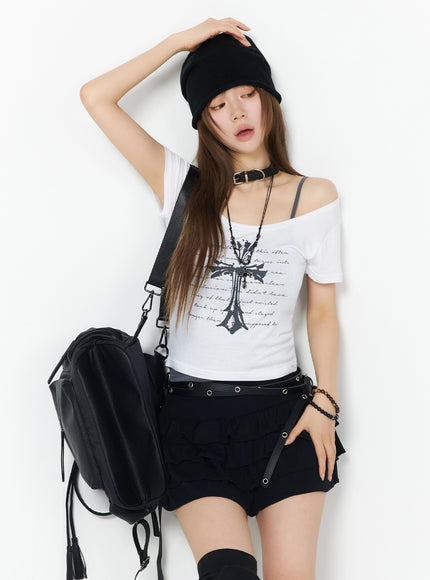 LEWKIN Gothic Cross Slim Fit Top IU525 White S/M front model shot with off-shoulder styling, black beanie, gothic cross print, paired with black cargo shorts