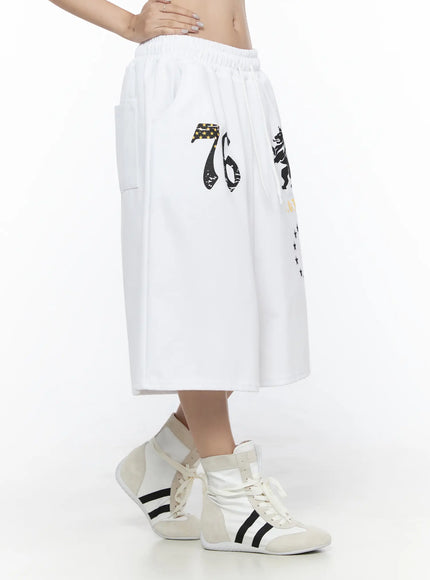 Graphic Bermuda Shorts CL524 White side view on model revealing deep side pocket and wide-leg silhouette with elastic waistband