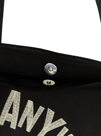 Graphic Canvas Tote Bag IL520 Black close-up interior detail showing silver magnetic snap closure at bag opening on black canvas lining