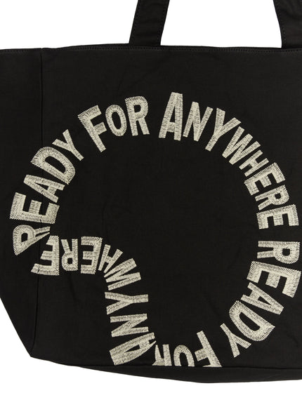 Graphic Canvas Tote Bag IL520 Black close-up front detail shot showing circular cream embroidered READY FOR ANYWHERE lettering on canvas