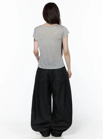 Graphic Casual Tee IL502 Gray back shot model showing plain back of semi-sheer lightweight crop tee with subtle texture paired with black wide-leg denim