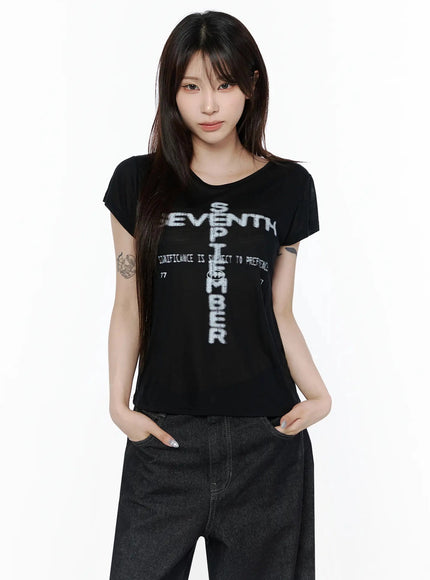 Graphic Casual Tee IL502 Black front shot model standing hands in pockets cross SEVENTH SEPTEMBER graphic print semi-sheer crop tee with dark jeans