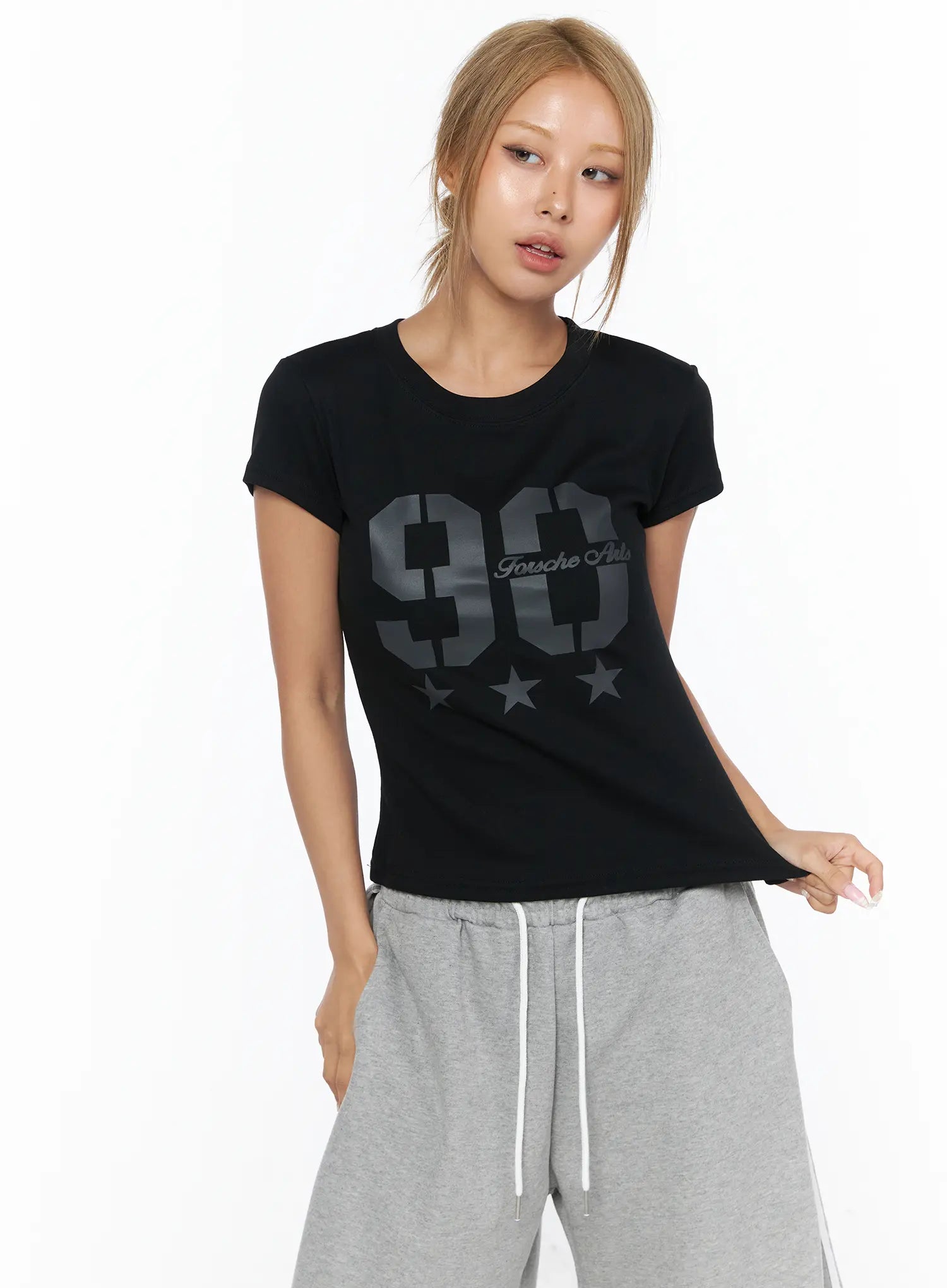 Graphic Crop Tee CU523 Black front shot on model, tone-on-tone dark gray 90 star graphic print, slim crop silhouette, styled with gray drawstring wide-leg pants