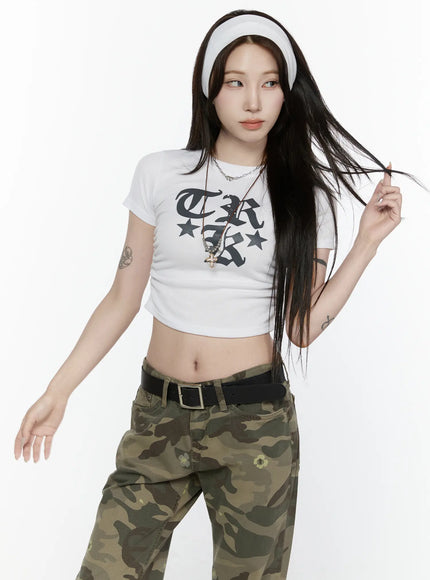 Graphic Crop Top IL522 White front model dynamic pose hair toss gothic print ribbed crop tee midriff exposed camo pants belt styling