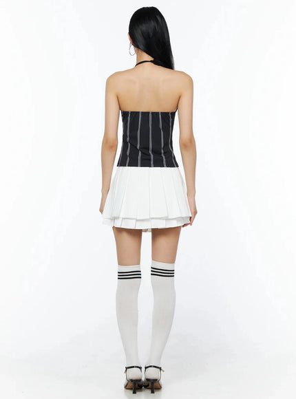 Graphic Lace Halter Top IL509 Black full-body back model shot revealing open bare back lace halter neck tie and black pinstripe top with white pleated skirt
