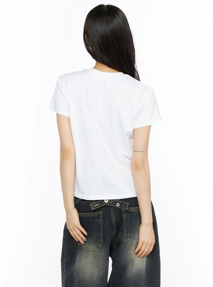 Graphic Meow Crop Tee CU530 White back three-quarter model showing clean white back cropped cut styled with red cap black scarf and wide-leg jeans